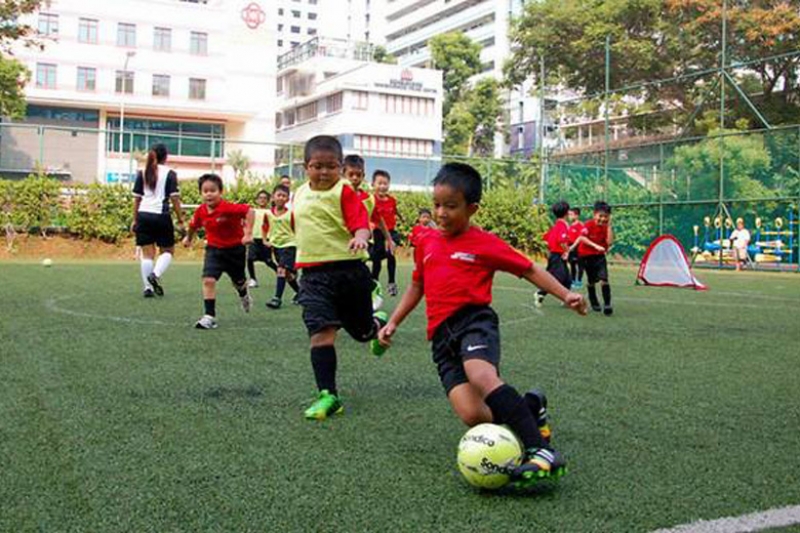 Children playing football at a primary school in Singapore
